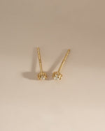 Gold top-view of dainty pearl stud earrings by Sami Jewels showcasing small, elegant pearl embellishments on classic earrings.