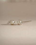 Sterling silver dainty pearl stud earrings by Sami Jewels featuring small, elegant pearl accents on classic earring posts.