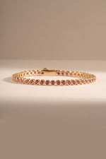 Dainty gold Ruby Bezel Tennis Bracelet by Sami Jewels featuring small round rubies set in a sleek gold bezel design.