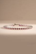 Dainty silver Ruby Bezel Tennis Bracelet by Sami Jewels featuring small red gemstones on a sleek bracelet design.