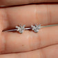 closeup image of silver stud earrings with a bee earring design