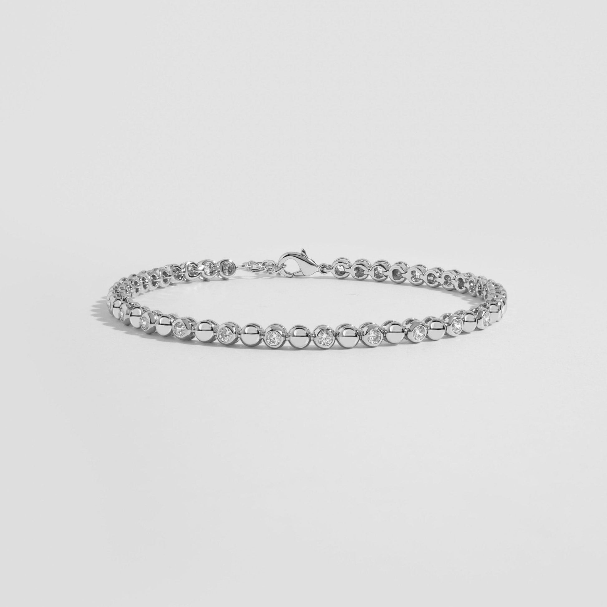 Silver diamond tennis bracelet gift for her, shown on white marble background