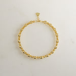 Close-up of a gold dainty bracelet in gold
