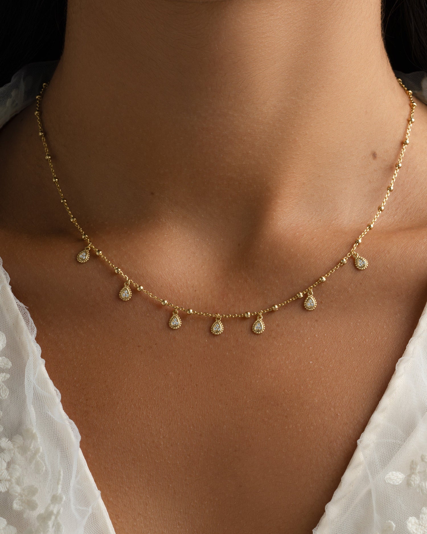 Gold dangling tear drop necklace from Sami Jewels featuring a delicate, elegant pendant on a fine chain.