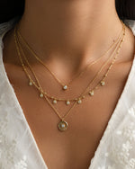 Gold dangling tear drop necklace from Sami Jewels, featuring a delicate teardrop pendant on a fine chain.