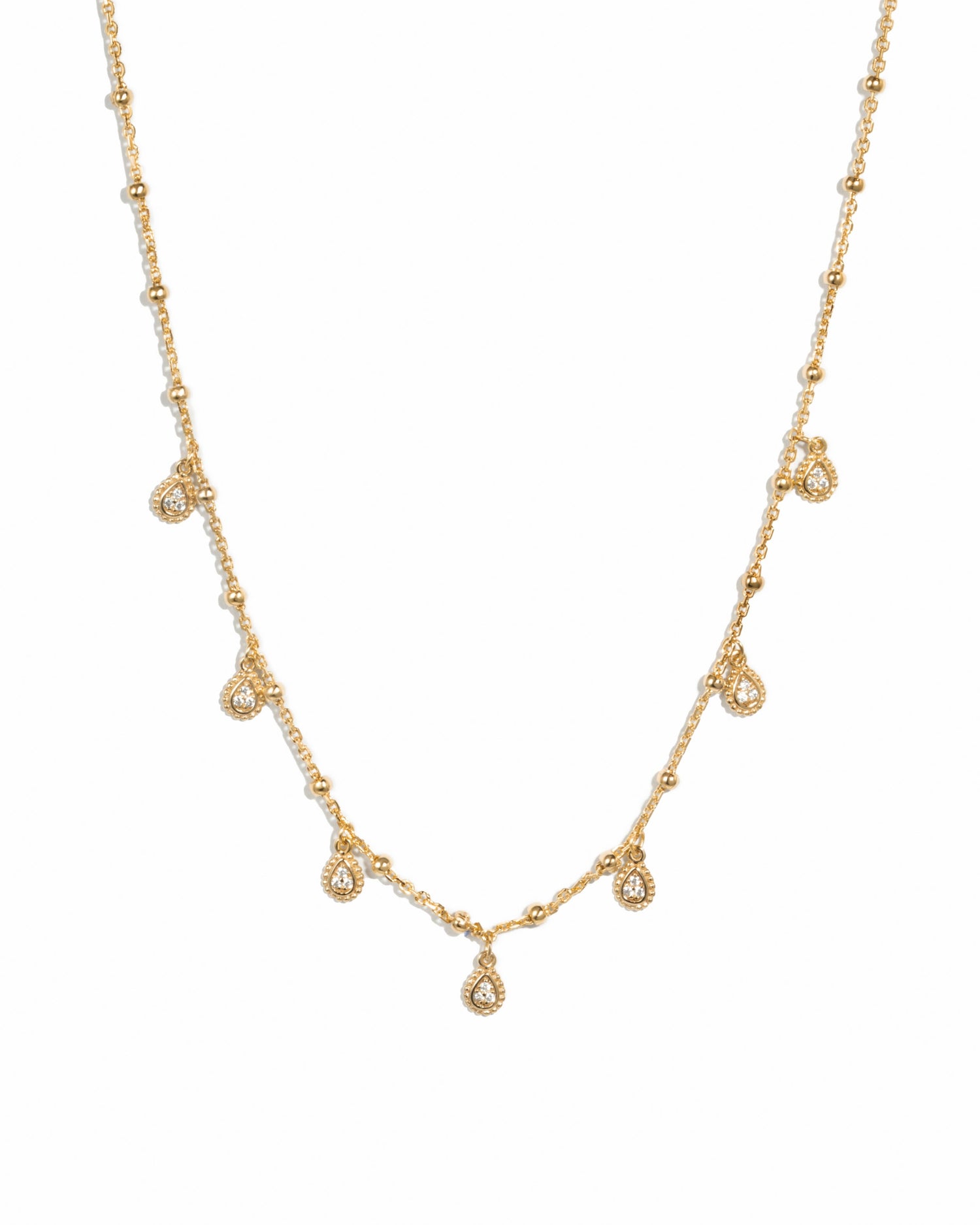 Gold dangling tear drop necklace by Sami Jewels, featuring a delicate teardrop pendant on a fine chain.