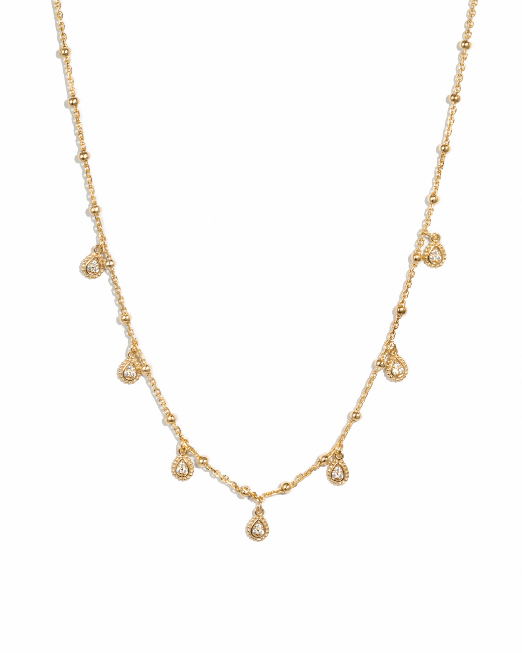 Gold dangling tear drop necklace by Sami Jewels, featuring a delicate teardrop pendant on a fine chain.