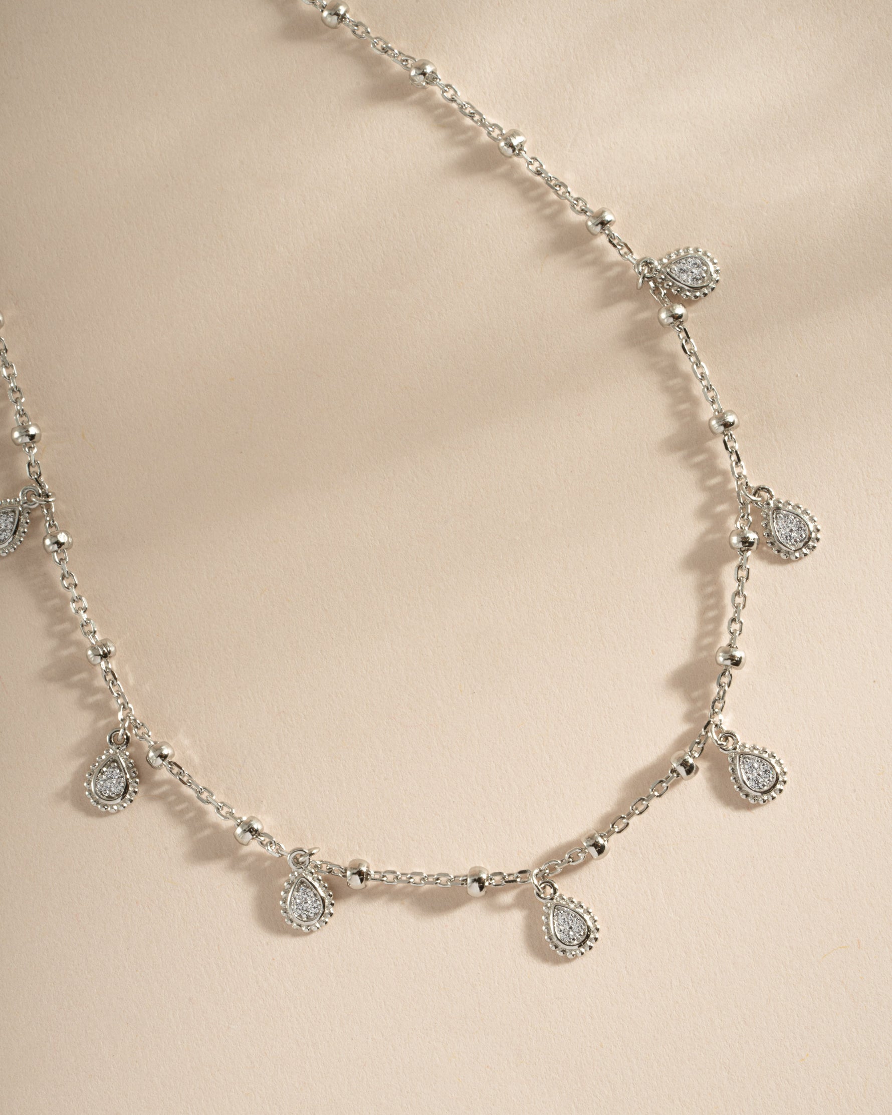 Sterling silver dangling tear drop necklace by Sami Jewels featuring a close-up of the elegant pendant.