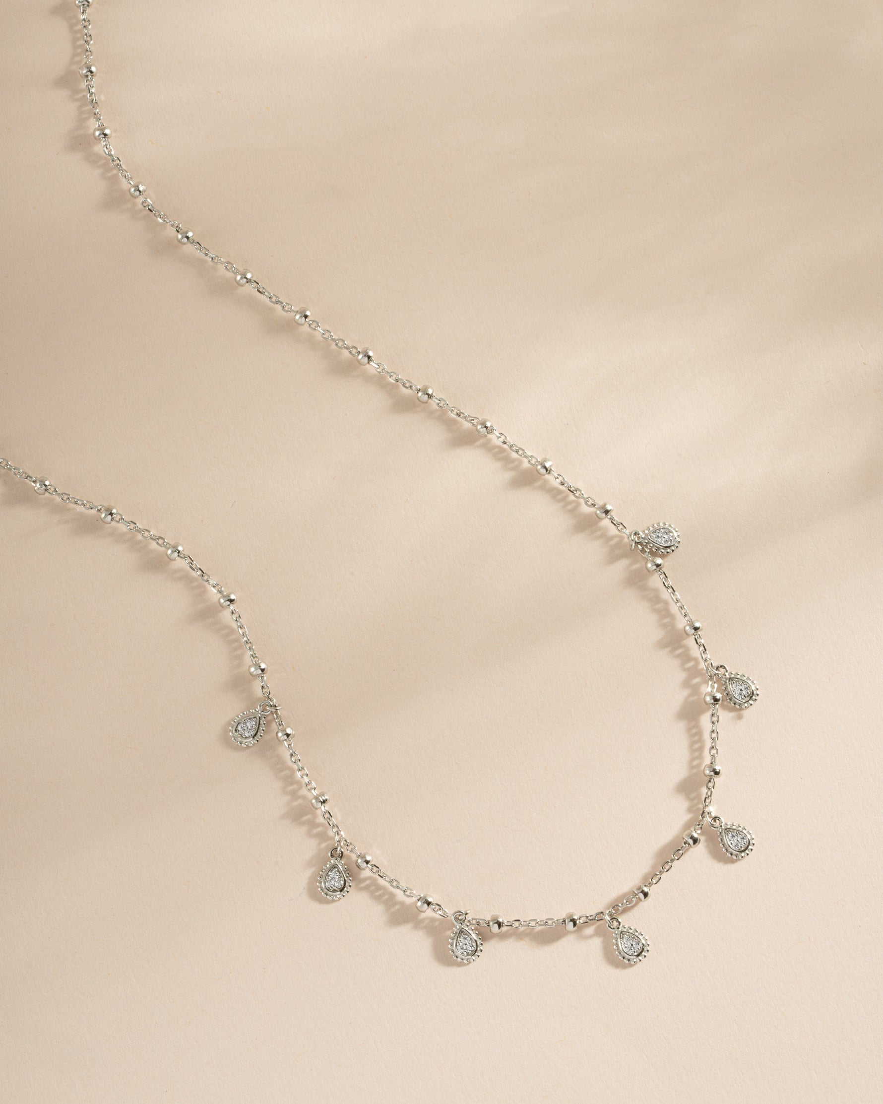 Sterling silver dangling tear drop necklace by Sami Jewels featuring a elegant drop pendant on a sleek chain.