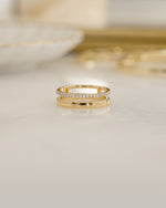 Gold double band ring by Sami Jewels featuring a diamond accent and a plain band design.