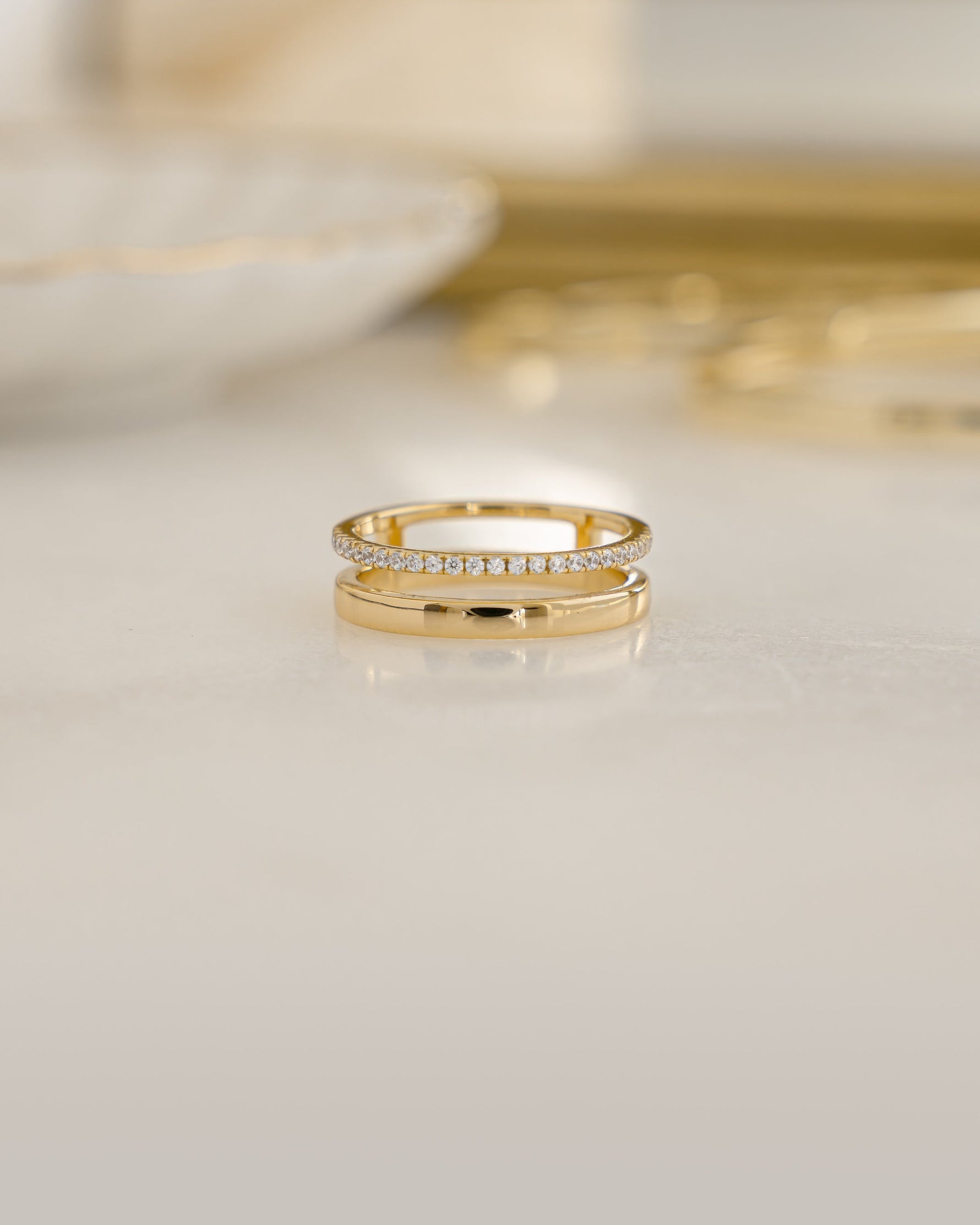 Gold double band ring by Sami Jewels featuring a diamond accent and a plain band design.