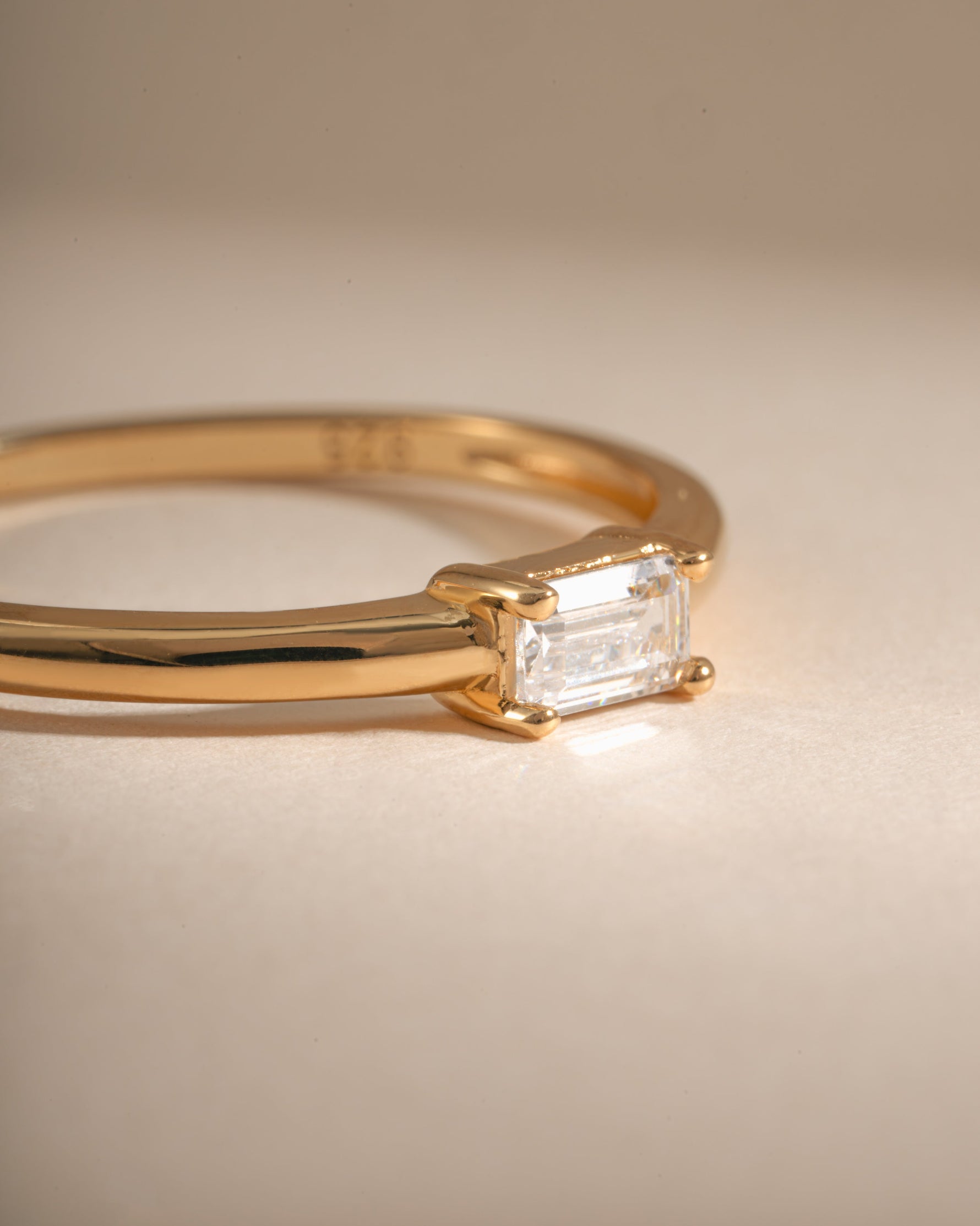 Close-up of Sami Jewels Diamond Lori Baguette Ring with gold band and sparkling diamond baguette stone.