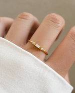 White CZ baguette ring by Sami Jewels featuring a sleek gold band and elegant diamond-style baguette stones.