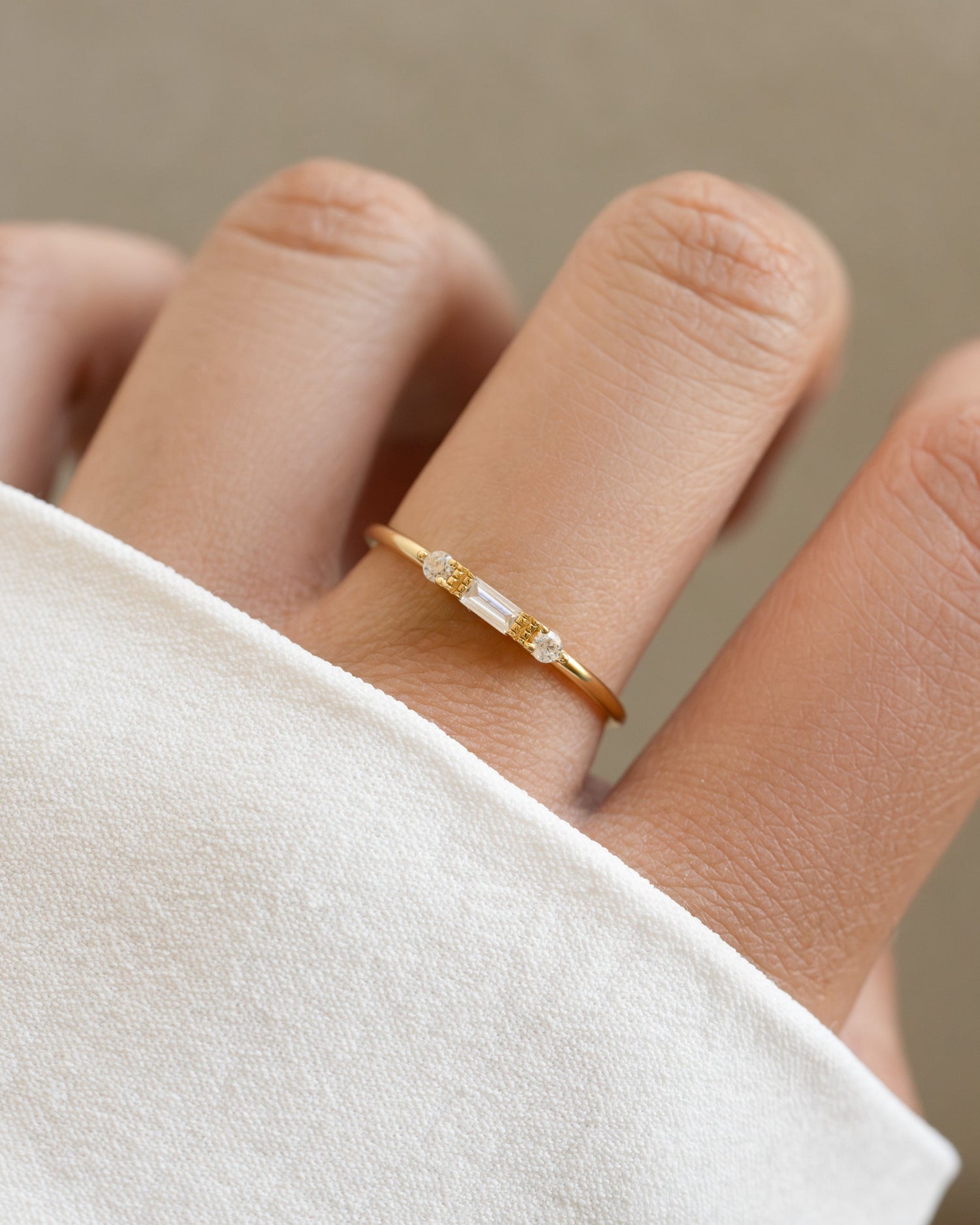 White CZ baguette ring by Sami Jewels featuring a sleek gold band and elegant diamond-style baguette stones.