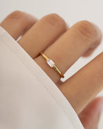 Sami Jewels Diamond Lori Baguette Ring on a model's finger, featuring gold band with rectangular diamond baguette accents.