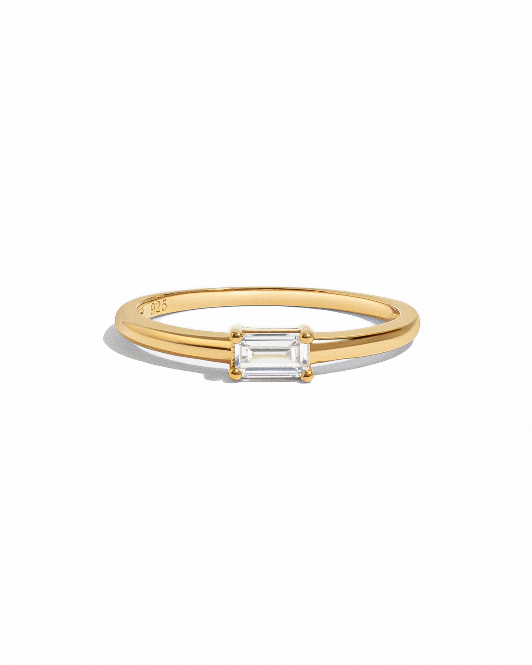 Sami Jewels Lori Baguette Ring with sparkling diamond baguette accents on gold band, displayed on a white background.