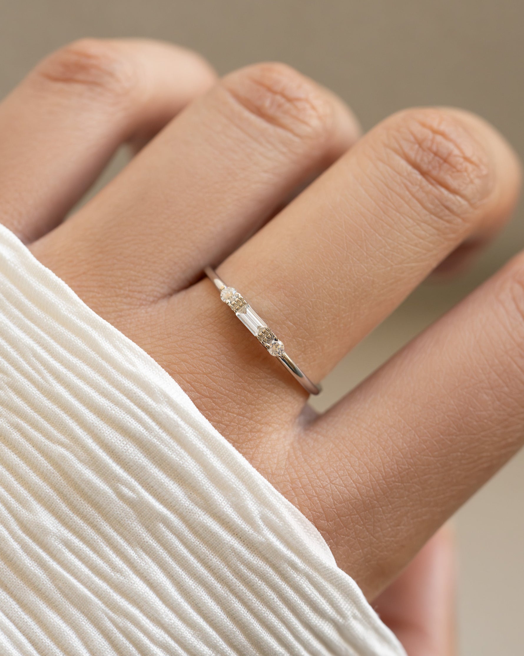 White CZ Baguette Ring by Sami Jewels featuring a sterling silver band with a row of sparkling baguette-cut cubic zirconia stones.
