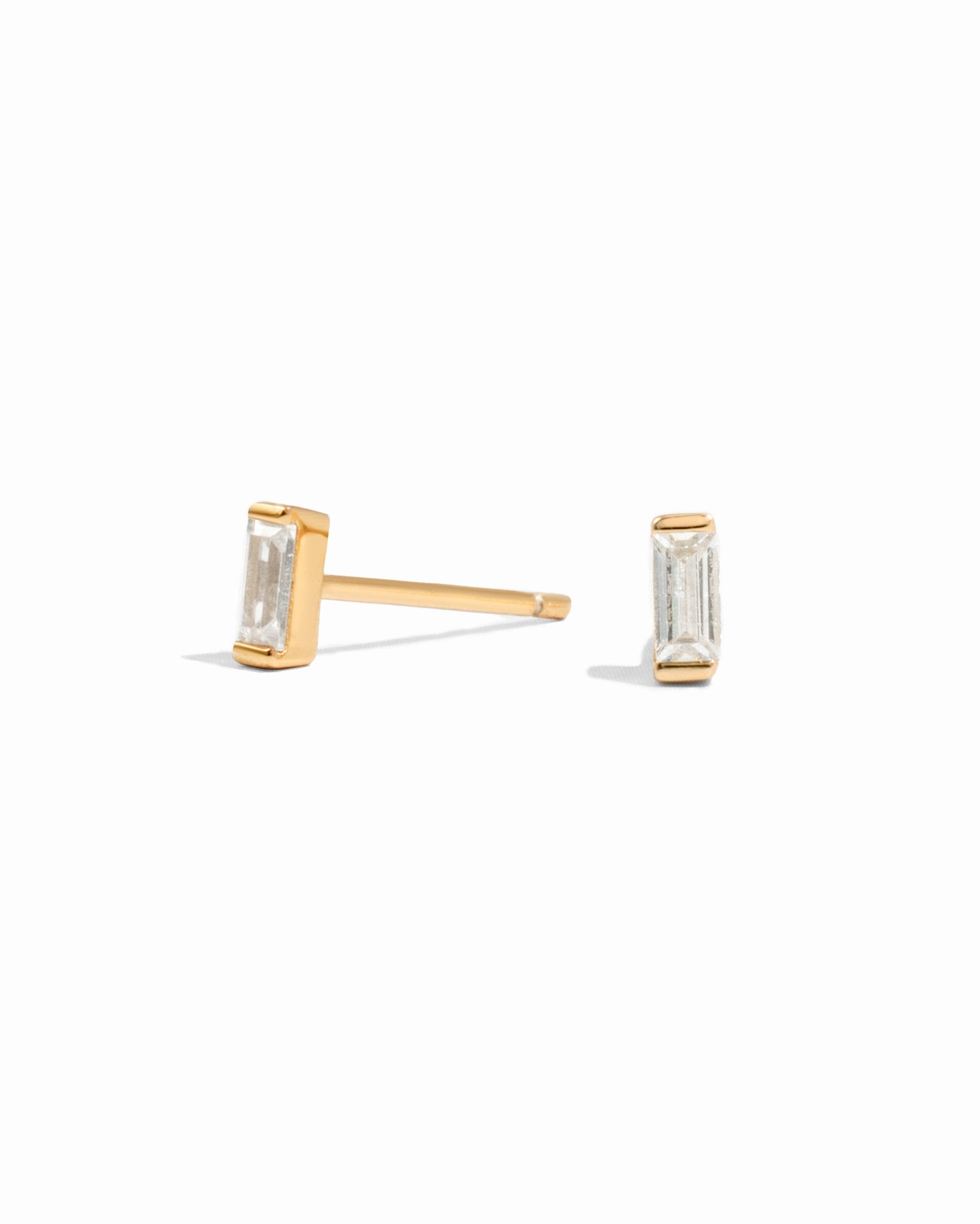 White CZ baguette stud earrings by Sami Jewels, featuring sparkling diamond-like stones on a clean white background.