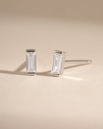 White CZ Baguette Stud Earrings by Sami Jewels featuring sterling silver setting and sparkling baguette-cut cubic zirconia.