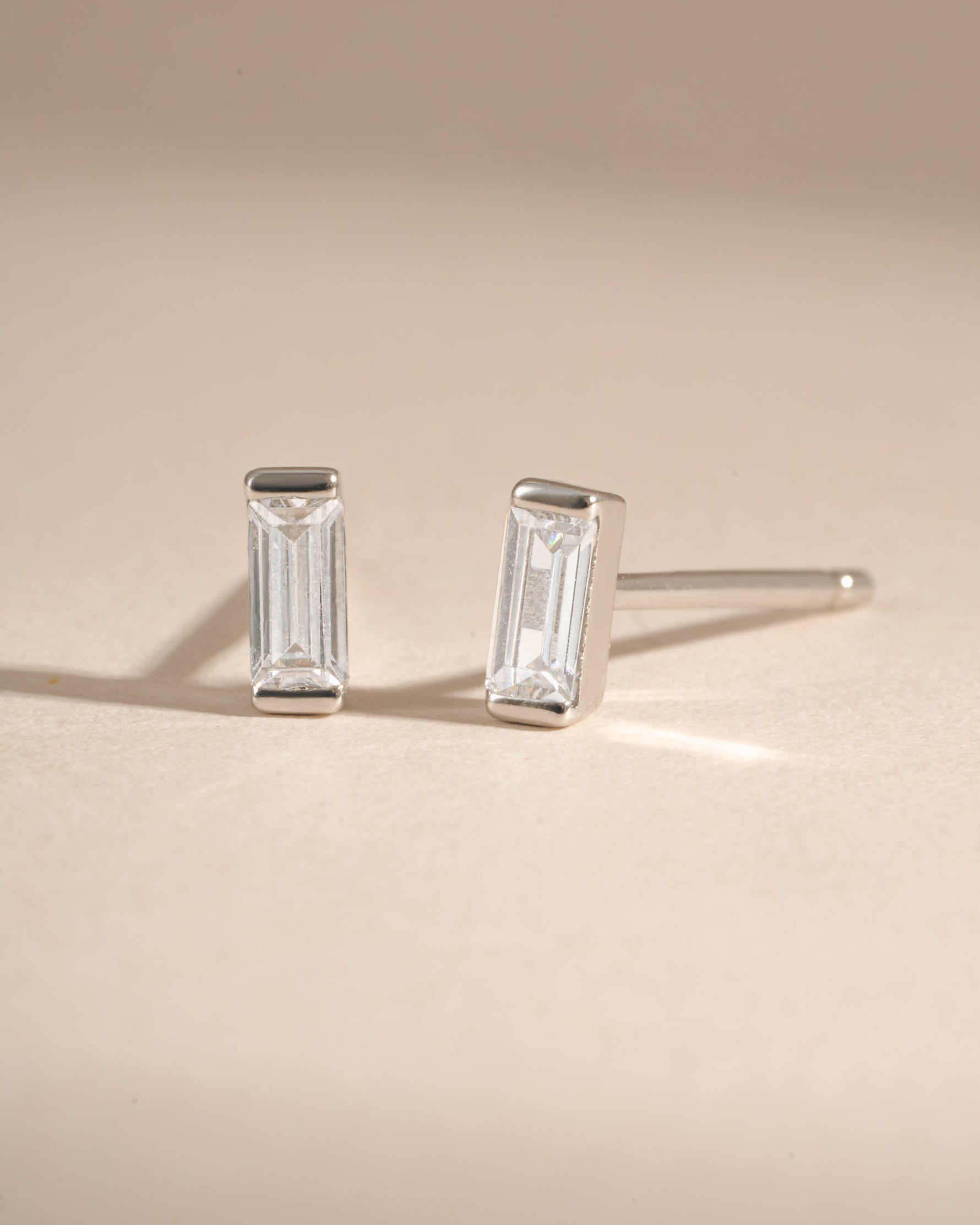 White CZ Baguette Stud Earrings by Sami Jewels featuring sterling silver setting and sparkling baguette-cut cubic zirconia.