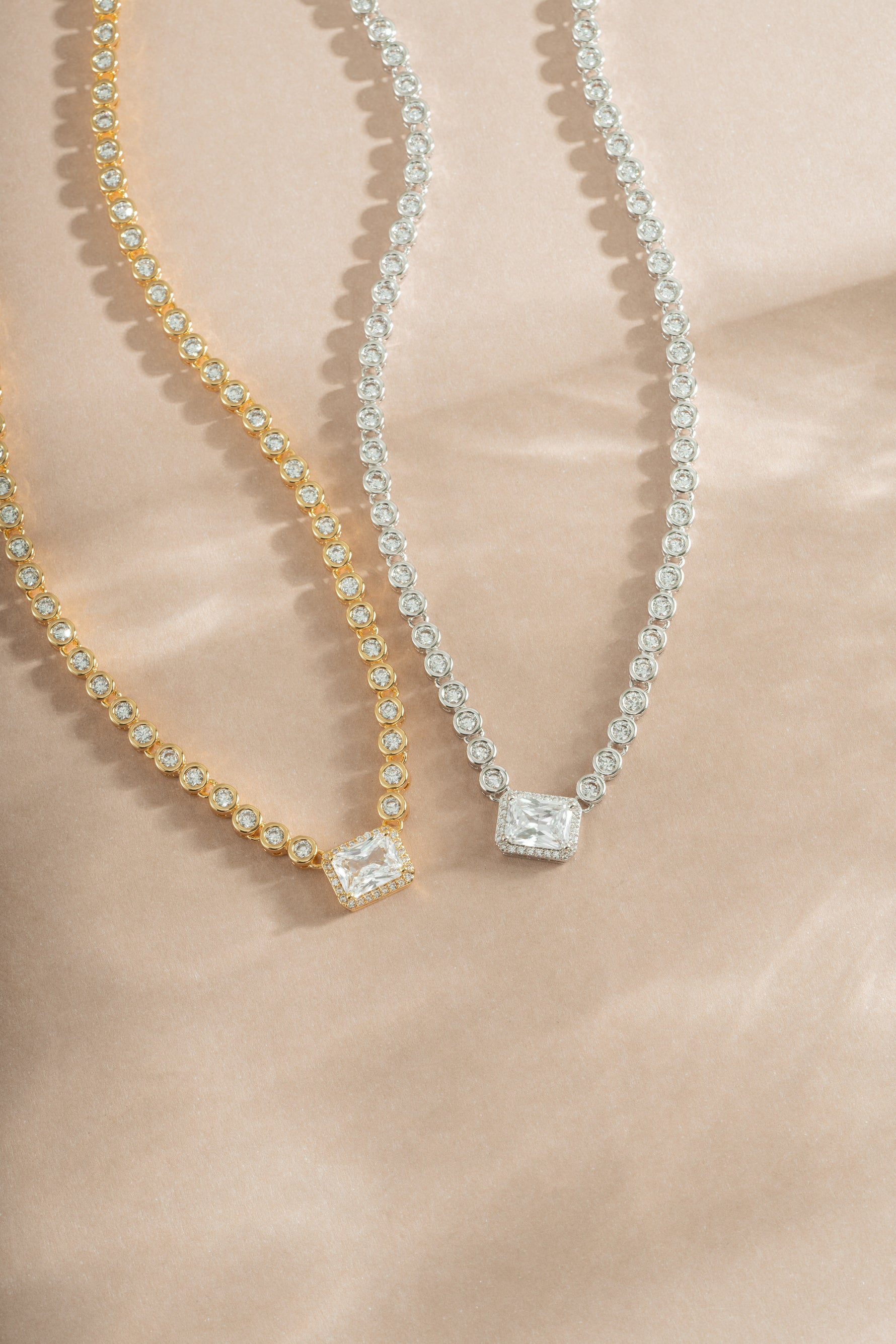 Elegant Sami Jewels diamond baguette tennis necklace featuring gold and silver links, showcasing sparkling rectangular-cut diamonds.