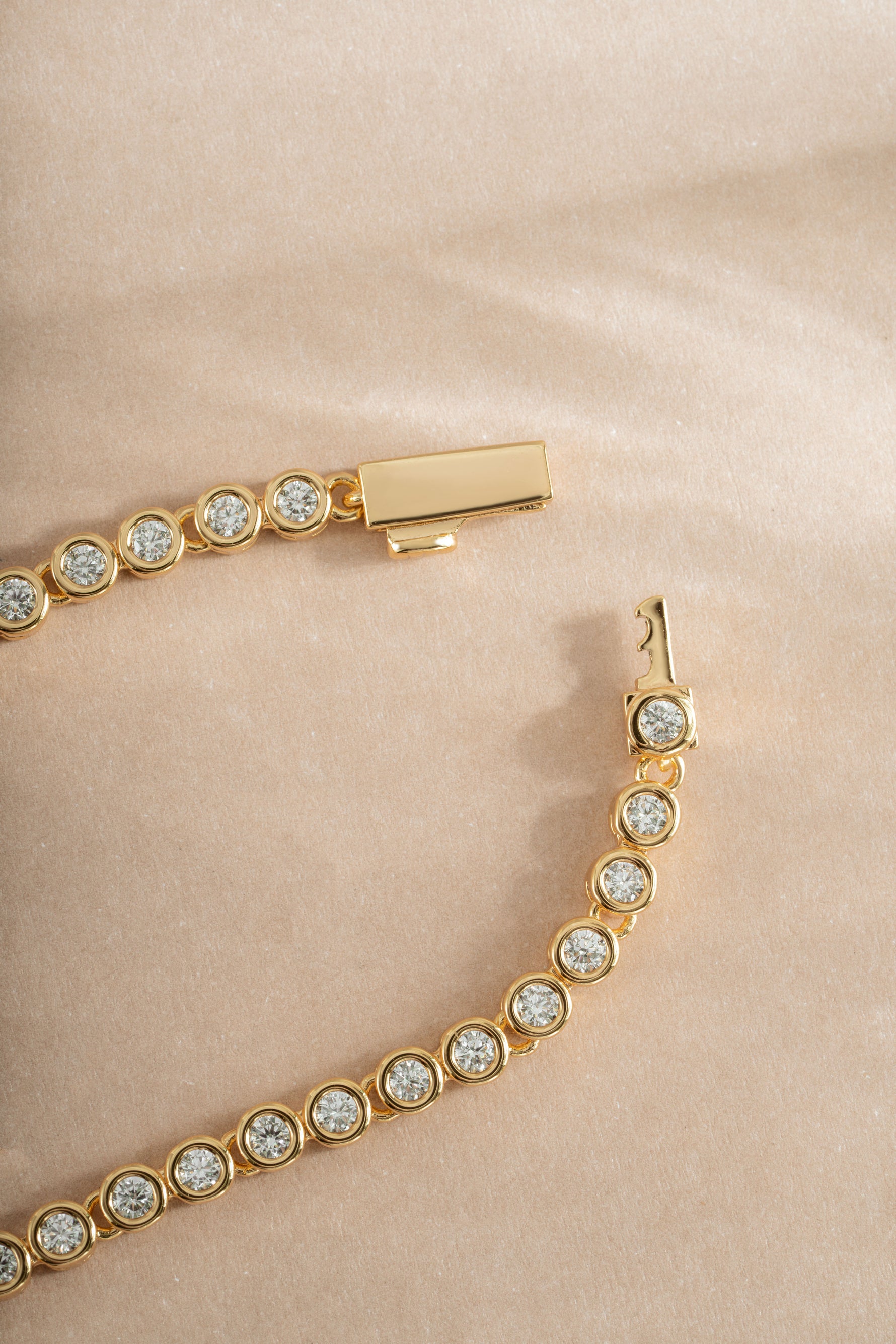 Gold diamond baguette tennis necklace with box clasp from Sami Jewels, featuring sparkling rectangular-cut diamonds.