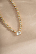 Close-up of Sami Jewels diamond baguette tennis necklace in gold, showcasing sparkling rectangular-cut diamonds on a delicate chain.