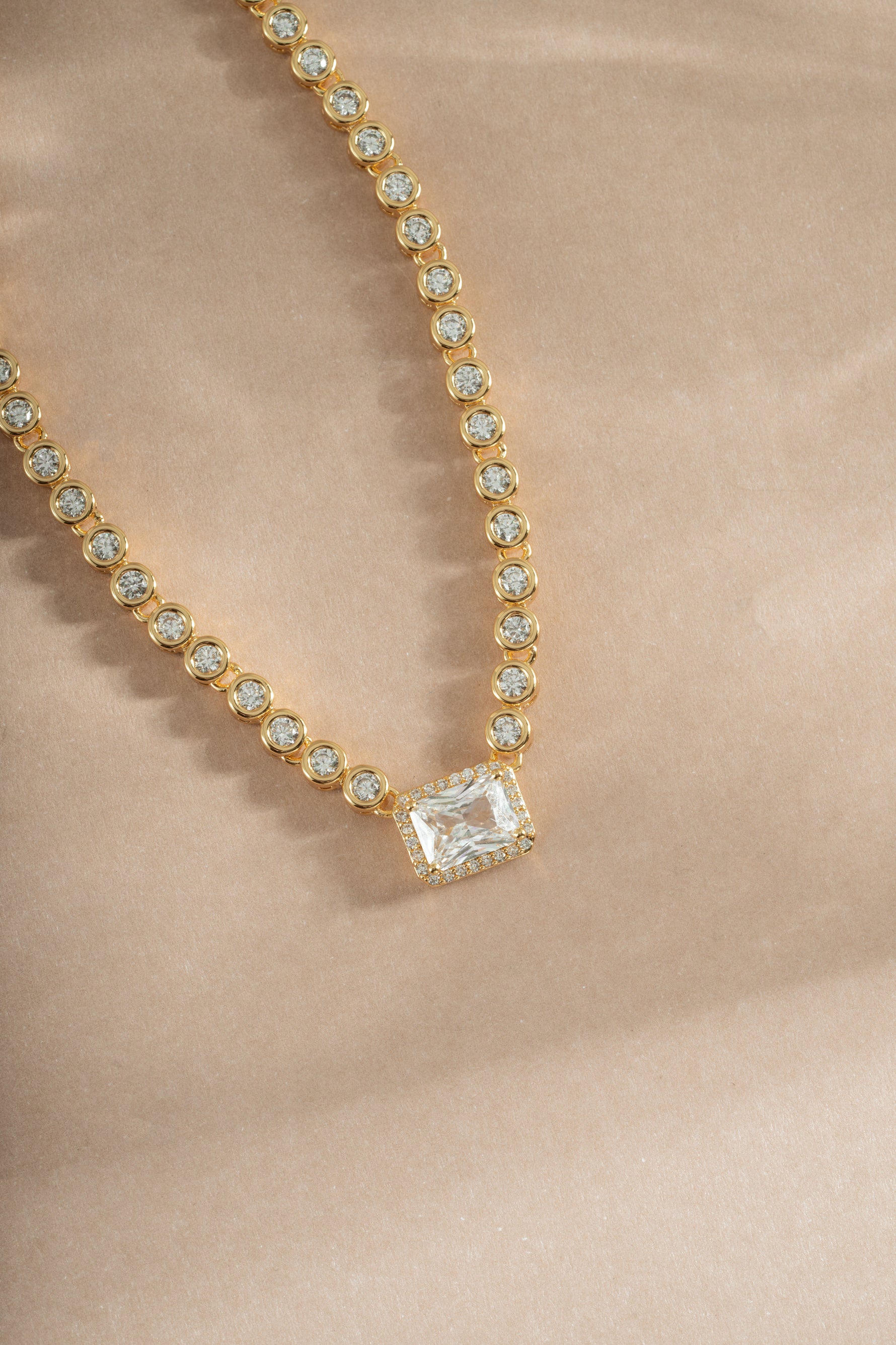 Close-up of Sami Jewels diamond baguette tennis necklace in gold, showcasing sparkling rectangular-cut diamonds on a delicate chain.