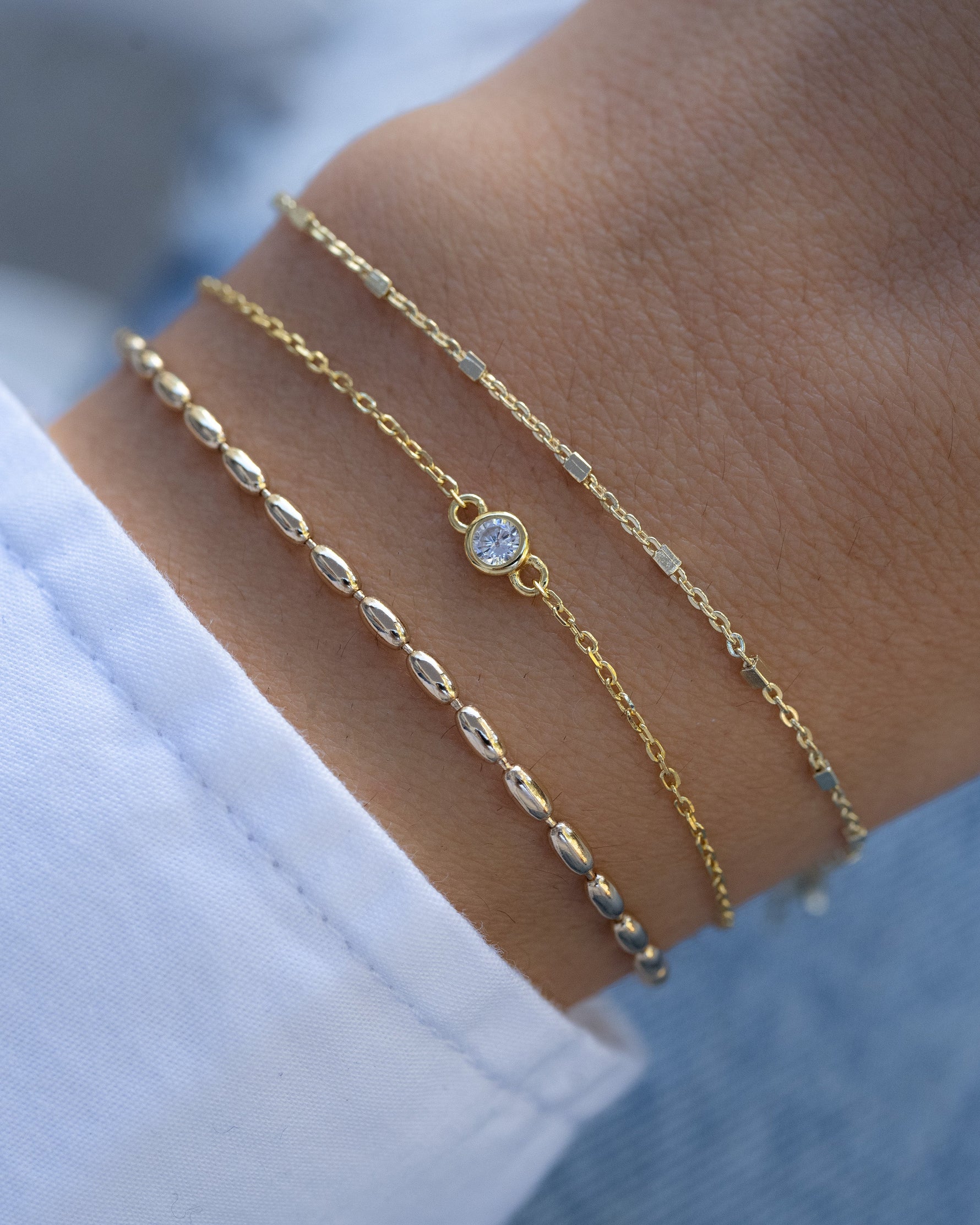 Gold diamond bezel bracelet stack by Sami Jewels, featuring elegant diamond accents and a sleek bracelet design.