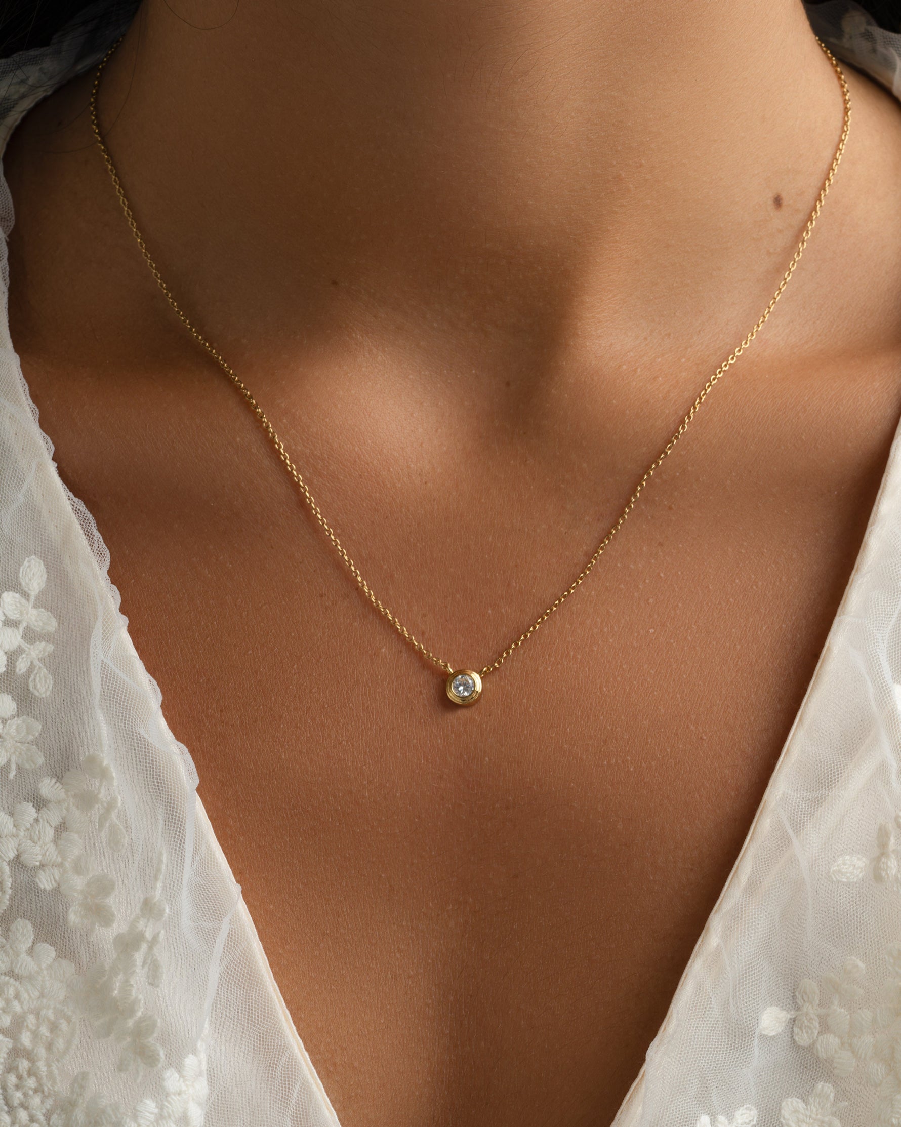 Gold Tiny Bezel Necklace by Sami Jewels featuring a delicate diamond bezel pendant on a fine chain.