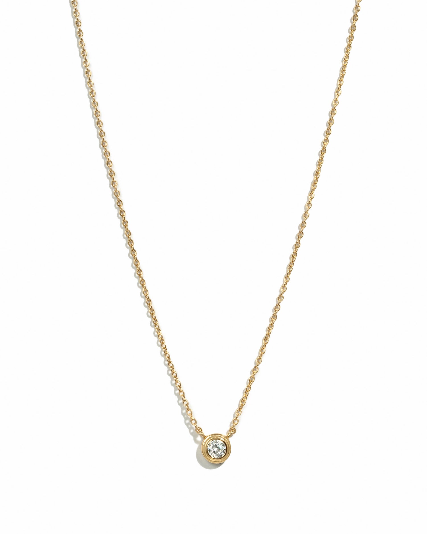 Gold Tiny Bezel Necklace by Sami Jewels featuring a small diamond bezel pendant on a delicate chain.