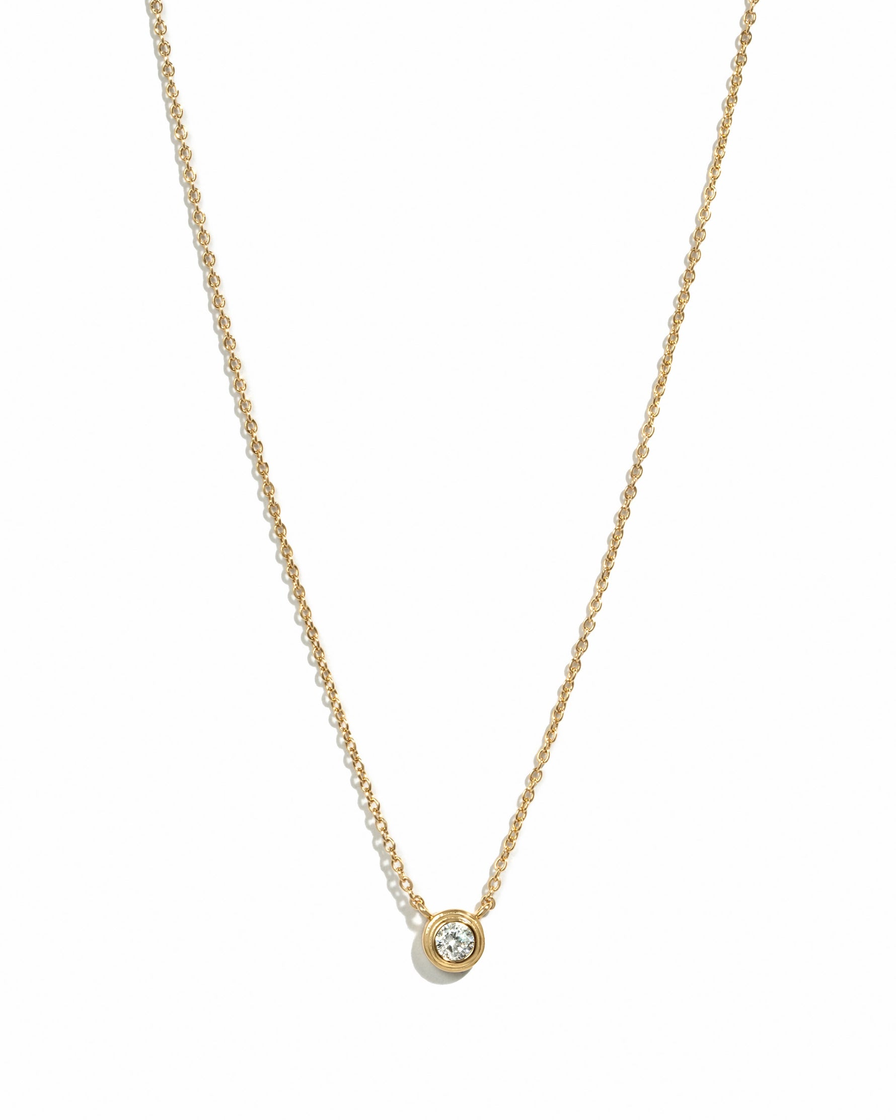 Gold tiny bezel necklace with a diamond accent from Sami Jewels, displayed on a white background.