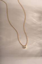 Gold Tiny Bezel Necklace by Sami Jewels featuring a delicate diamond bezel pendant on a fine chain.
