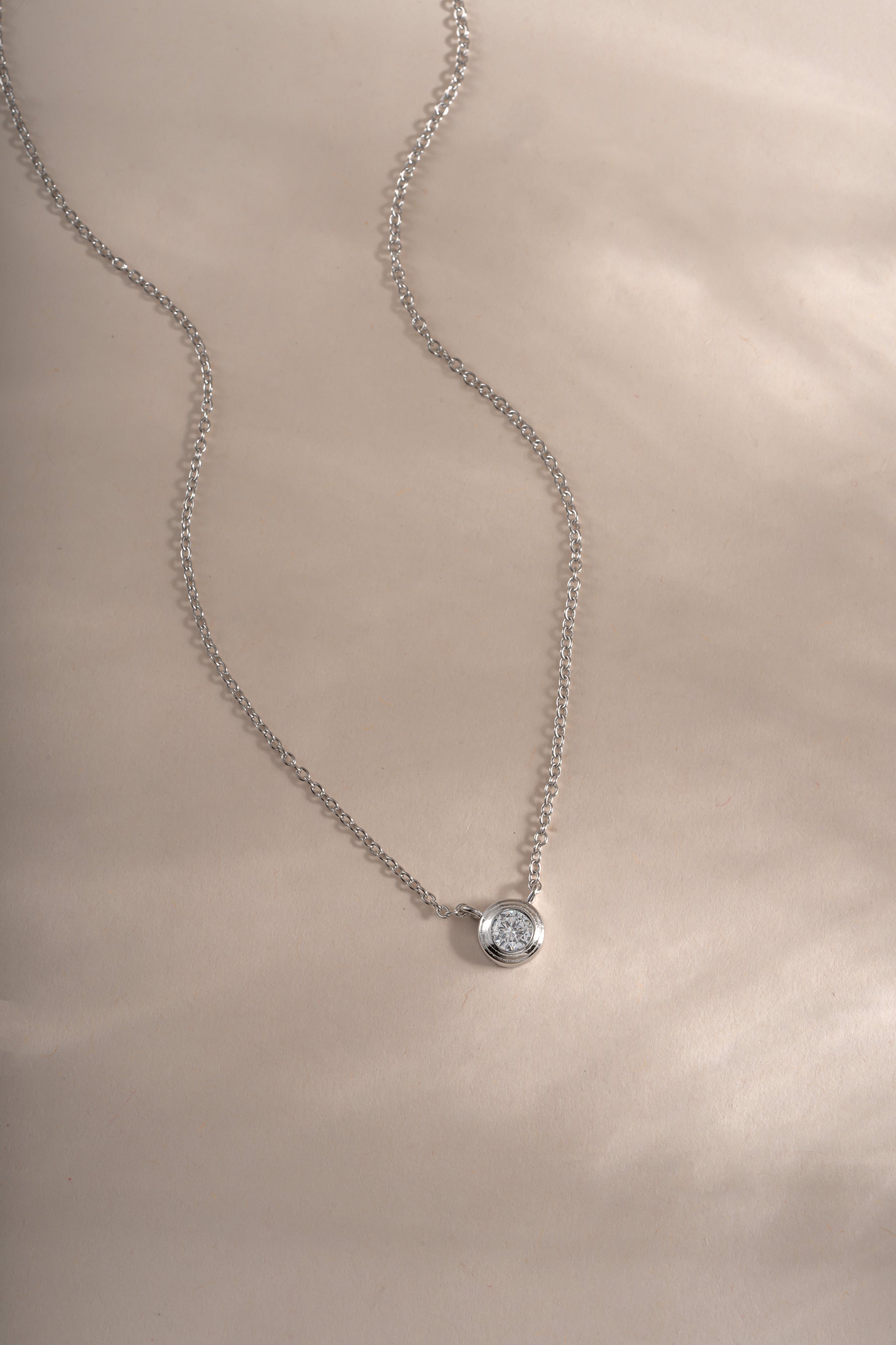 Sterling silver Tiny Bezel Necklace by Sami Jewels featuring a delicate diamond bezel pendant on a fine chain.