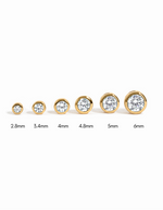 Sami Jewels diamond bezel stud earrings in various sizes, gold-tone, showcasing elegant, sparkling jewelry for pierced ears.