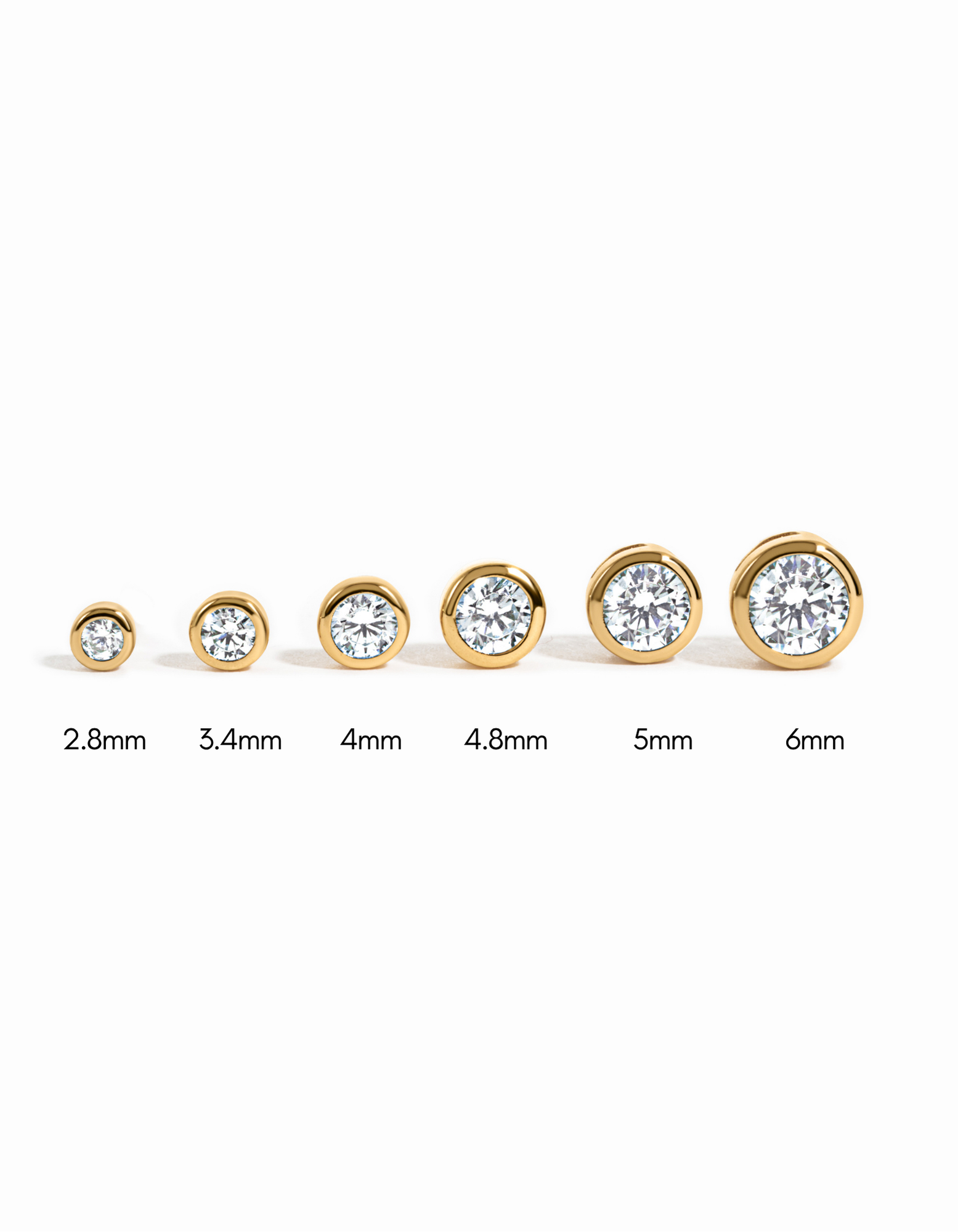 Sami Jewels diamond bezel stud earrings in various sizes, gold-tone, showcasing elegant, sparkling jewelry for pierced ears.