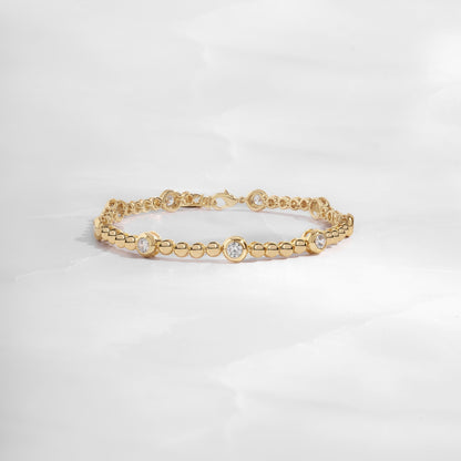 14k gold bracelet with small beads and large bezels.