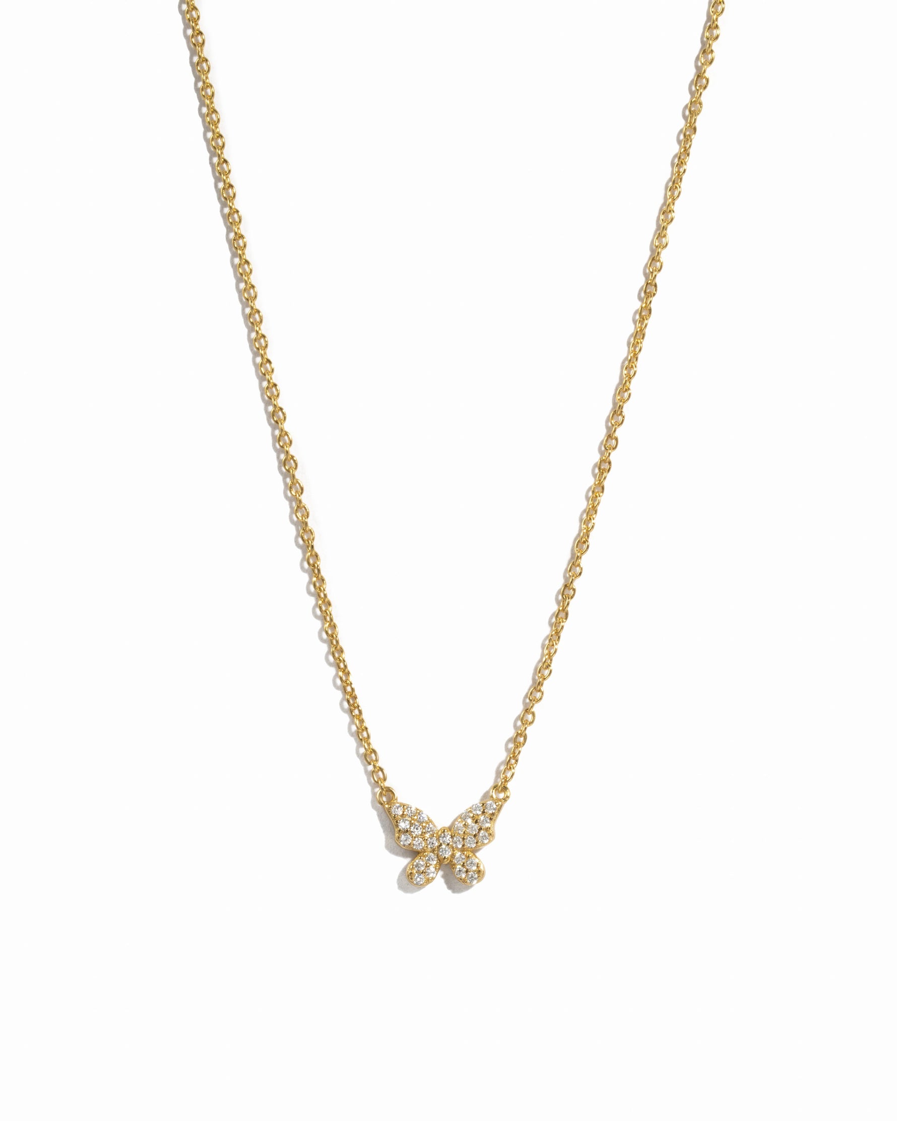 Gold butterfly necklace by Sami Jewels featuring a diamond-accented butterfly pendant on a white background.