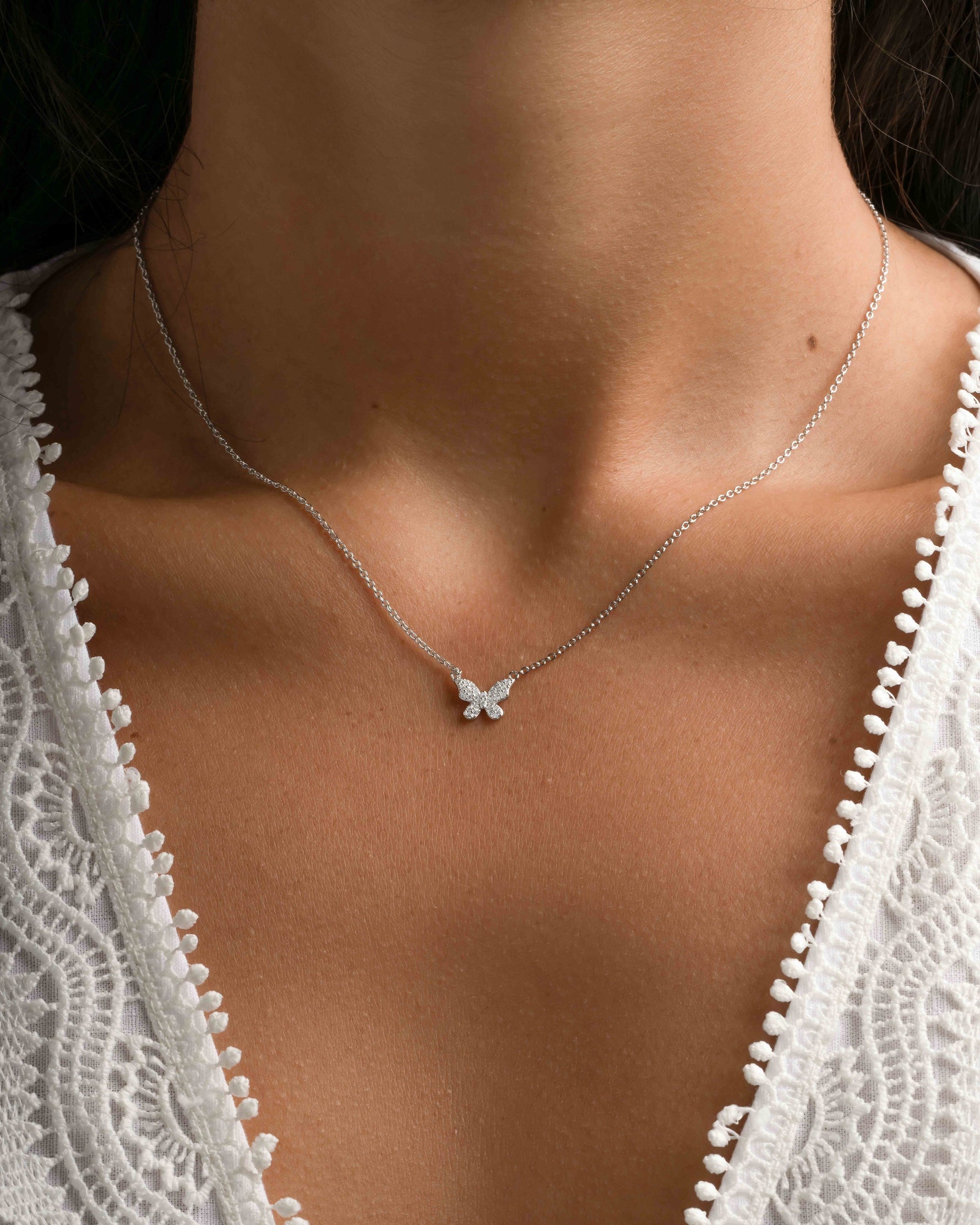 Sterling silver butterfly necklace with diamond accents by Sami Jewels, featuring a delicate butterfly pendant on a fine chain.