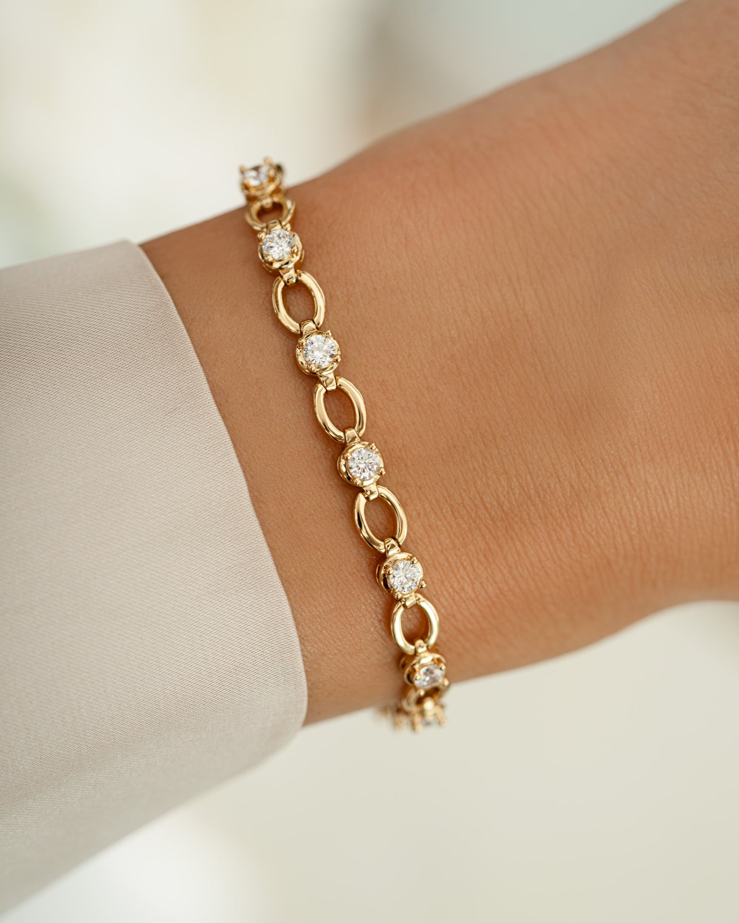 Gold Lilly tennis bracelet by Sami Jewels featuring a diamond chain design on a model.