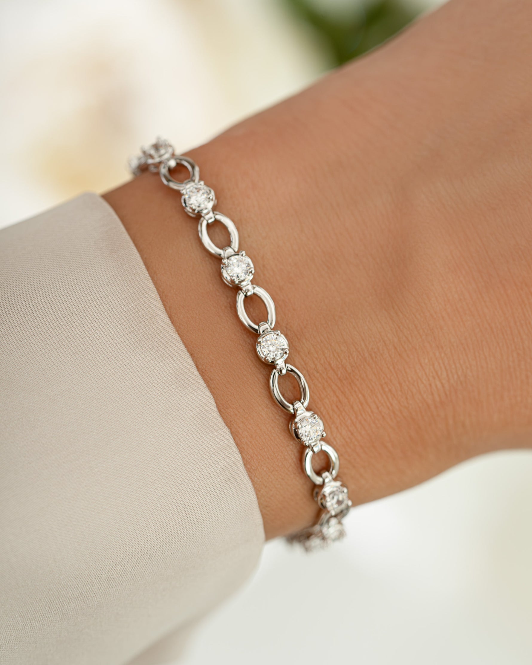 Silver Lilly Tennis Bracelet by Sami Jewels featuring a diamond-chain design on a model wrist.
