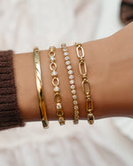 Gold Lilly Tennis Bracelet by Sami Jewels featuring a diamond chain design, styled in a stacked bracelet arrangement.