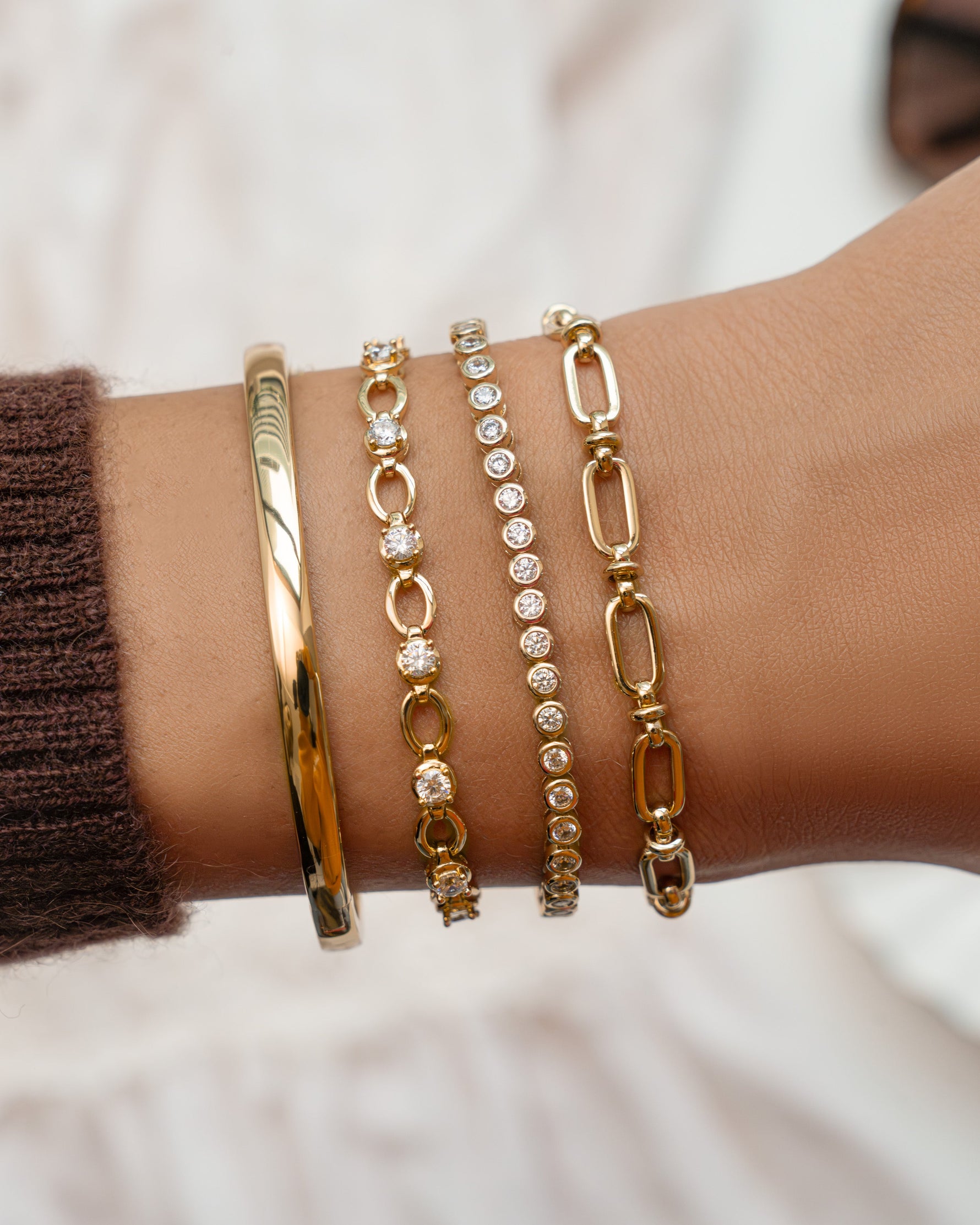 Gold Lilly Tennis Bracelet by Sami Jewels featuring a diamond chain design, styled in a stacked bracelet arrangement.