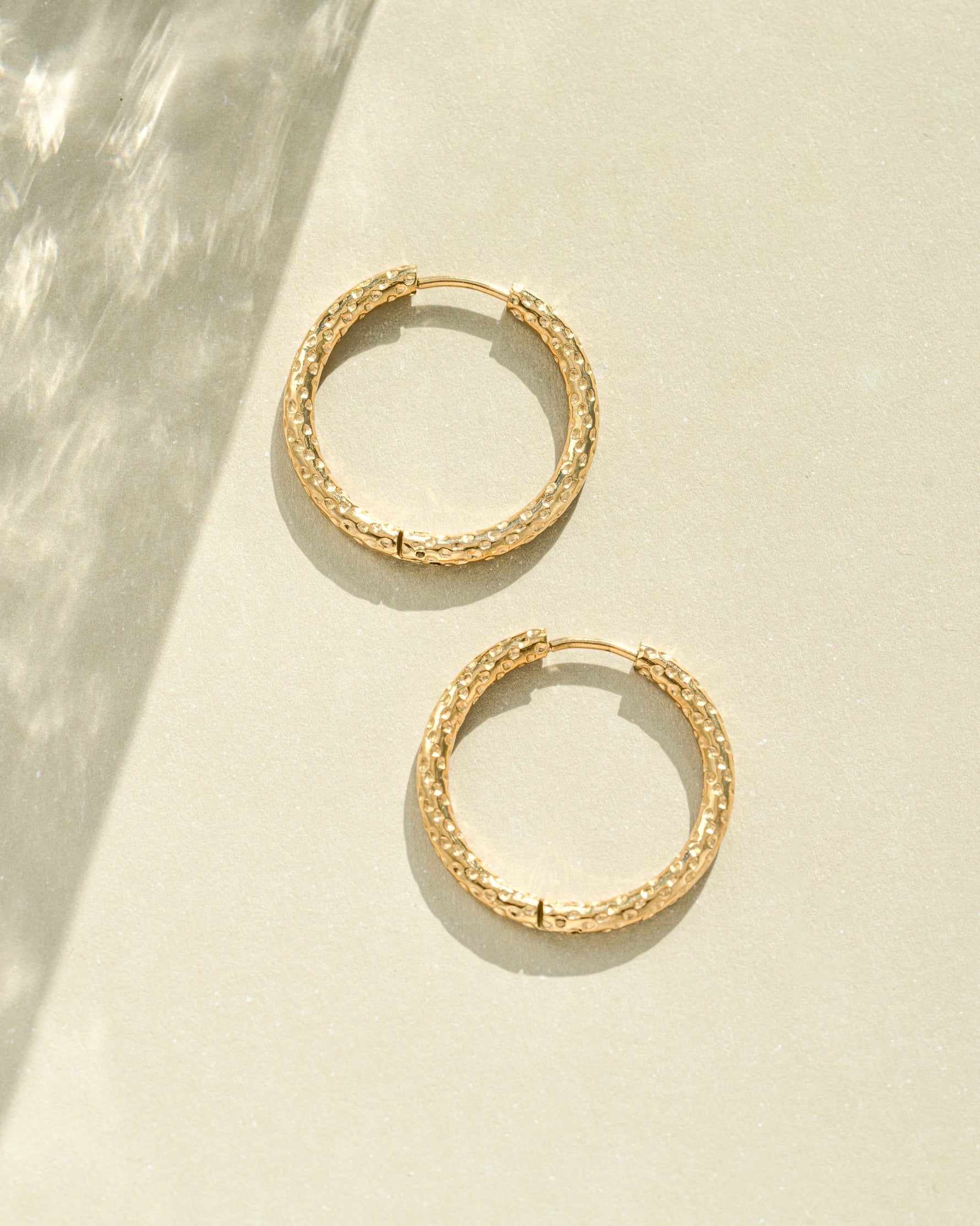 Gold stainless steel SS textured hoop earrings with diamond-cut design by Sami Jewels, waterproof and stylish jewelry accessory.