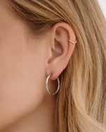 Silver stainless steel SS textured hoop earrings with diamond-cut design by Sami Jewels, waterproof and stylish accessory.