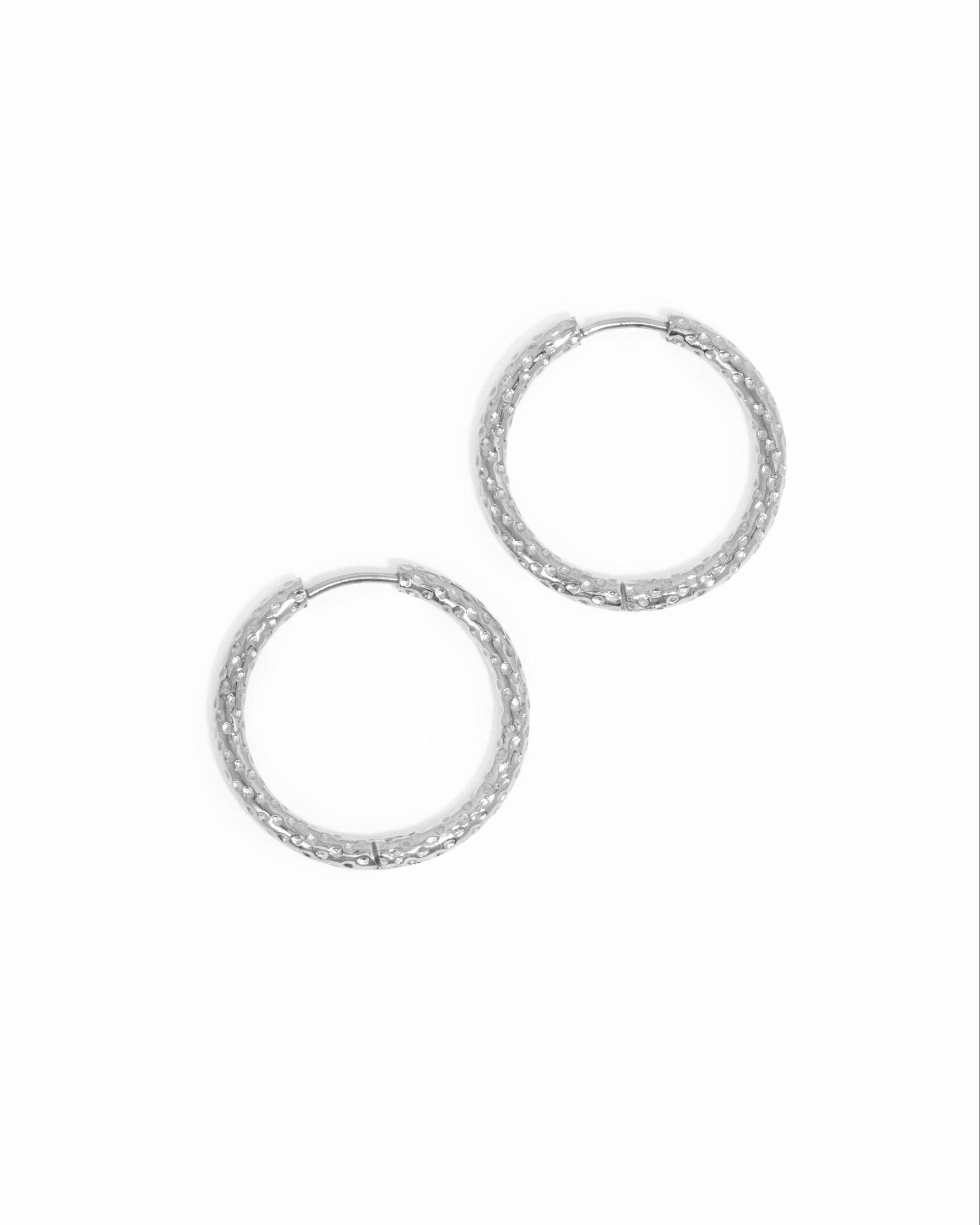 Silver stainless steel SS textured hoop earrings with diamond cut design from Sami Jewels.