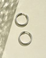 Silver stainless steel SS textured hoop earrings by Sami Jewels with diamond-cut design, waterproof and stylish.