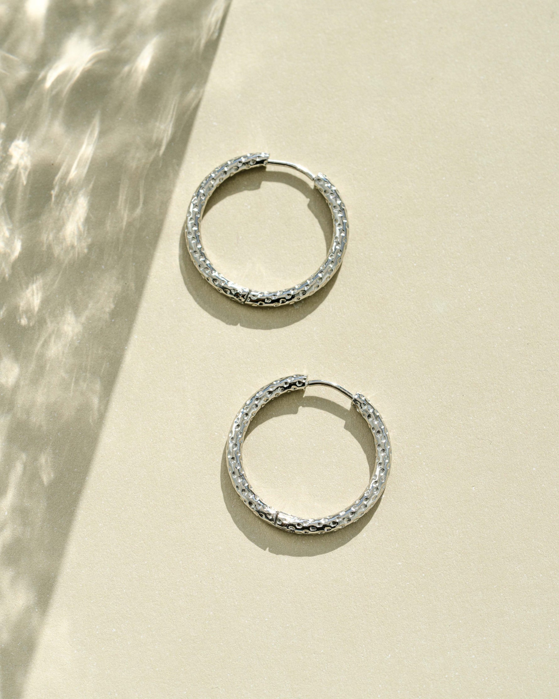 Silver stainless steel SS textured hoop earrings by Sami Jewels with diamond-cut design, waterproof and stylish.