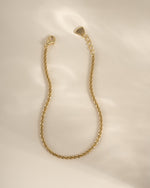 Close-up of a gold diamond-cut rope chain bracelet from Sami Jewels, showcasing intricate braided design and polished finish.