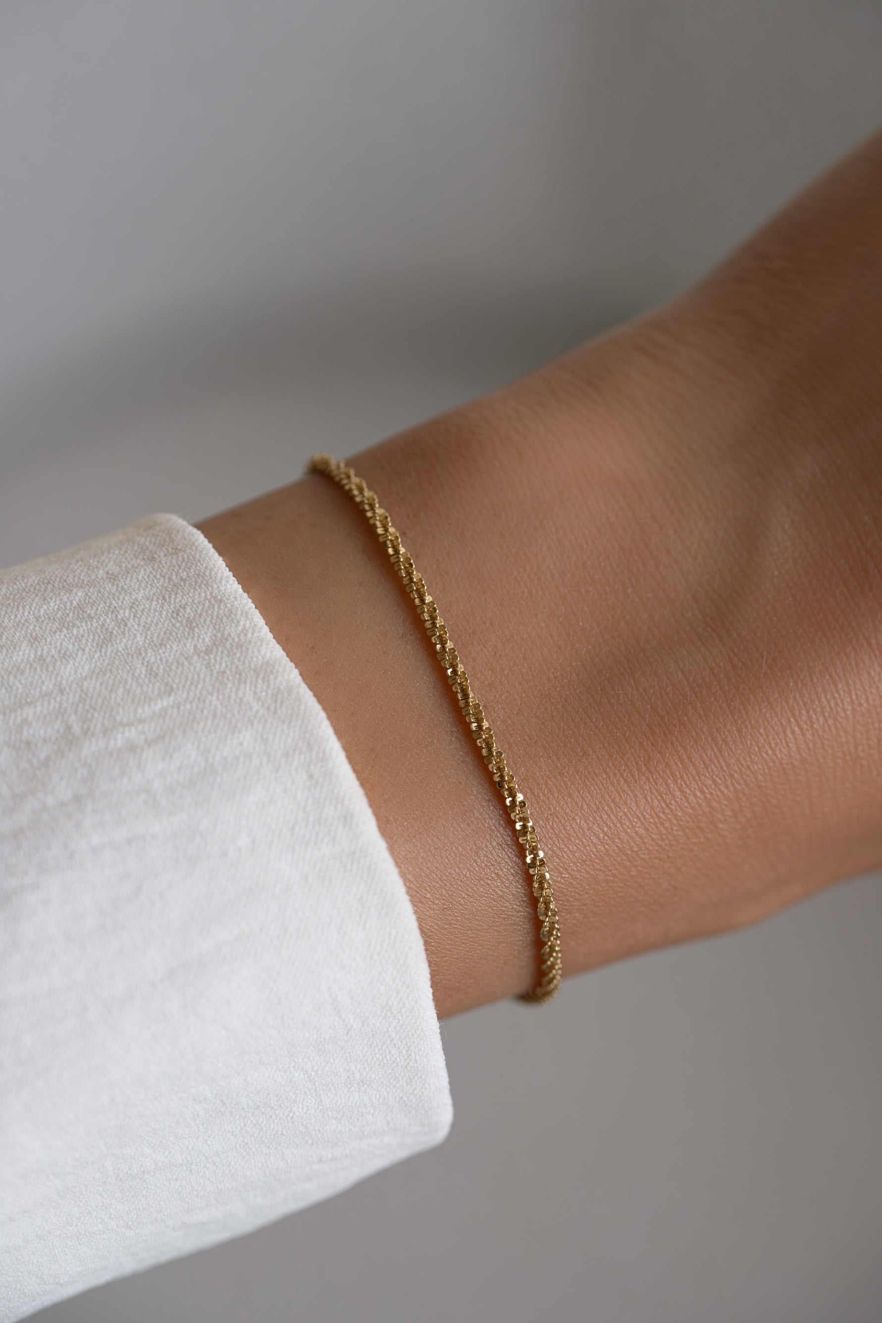 Gold diamond-cut rope chain bracelet by Sami Jewels featuring intricate textured links and a polished finish.